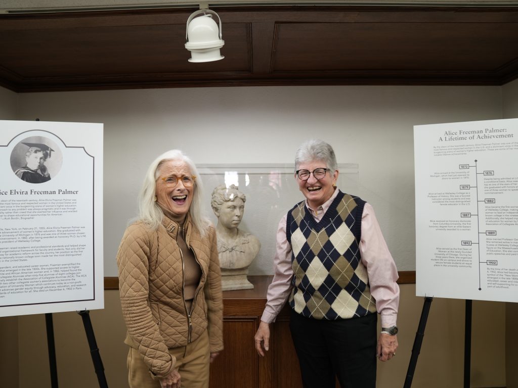 Meg Brown and Sheryl Szady stand in front of the restored Alice Freeman Palmer bust during the Nov. 1, 2023, dedication ceremony. 