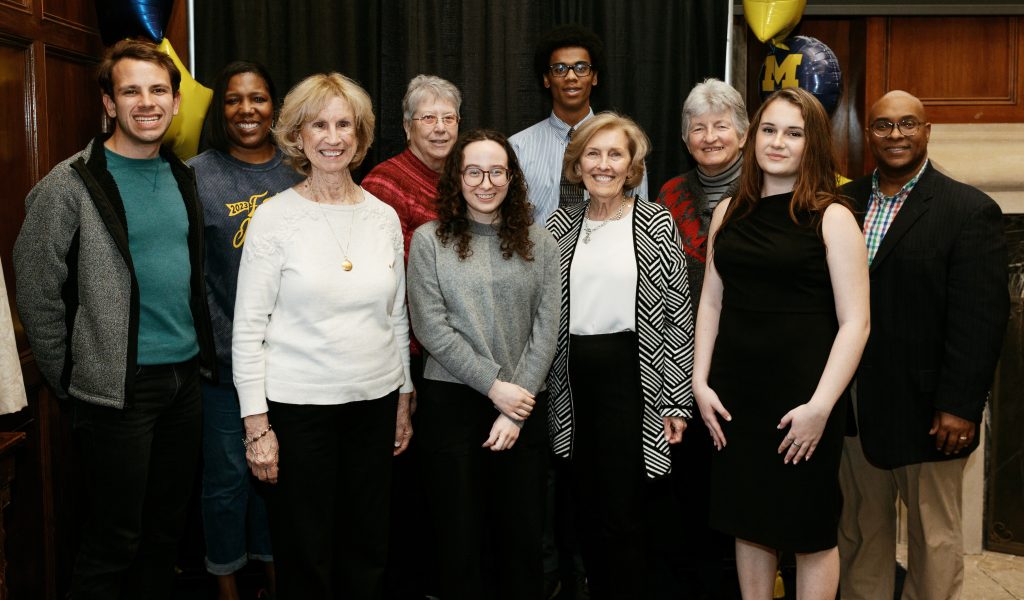 group photo of 10 people of different ages and races