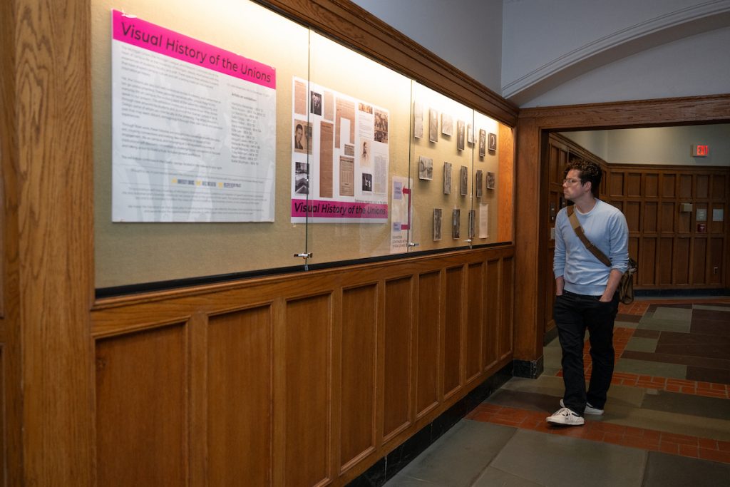 Glass display case where historic images and newspaper clippings of the student unions on campus are displayed.