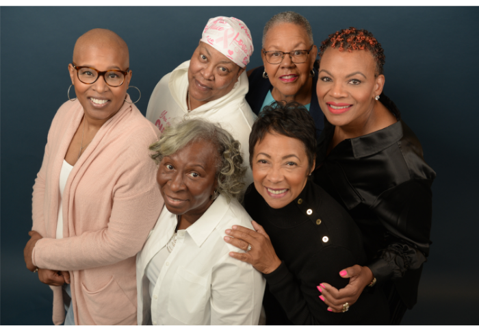 group of 6 Black women embracing looking up